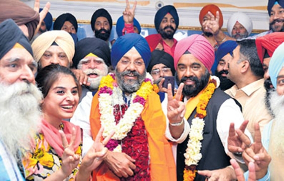 SAD (Badal) Delhi president and DSGMC chief Manjit Singh GK with SAD(Badal) leaders and supporters  flash the victory sign after  his won from Greater Kailash in DSGMC election at Gurdwara Rakab Ganj in New Delhi on Wednesday. Tribune photo: Manas Ranjan Bhui