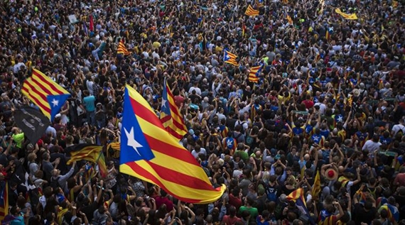 People wave "estelada" or pro independence flags outside the Palau Generalitat in Barcelona, Spain, after Catalonia's regional parliament passed a motion with which they say they are establishing an independent Catalan Republic, Friday, Oct. 27, 2017. (AP Photo/Emilio Morenatti)